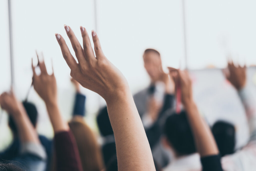 hands being raised at a meeting