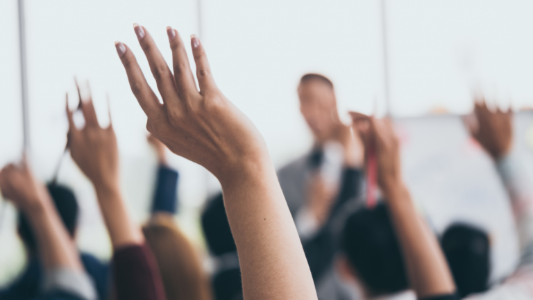 hands being raised at a meeting